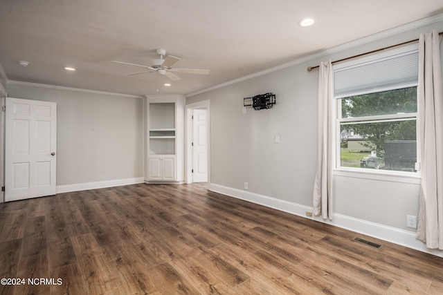 empty room featuring crown molding, wood-type flooring, and ceiling fan