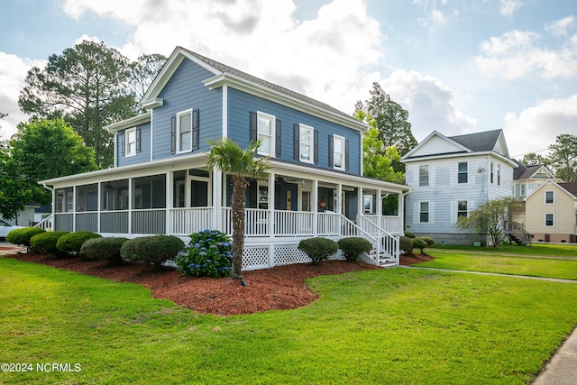 view of front of house featuring a front yard, covered porch, and a sunroom