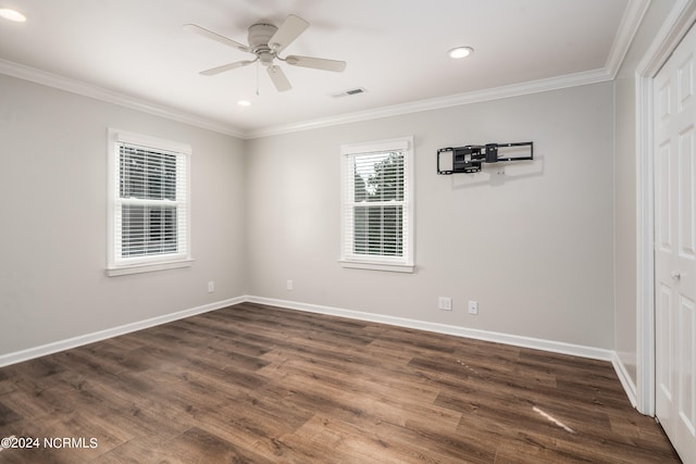 spare room featuring crown molding, ceiling fan, and dark hardwood / wood-style flooring