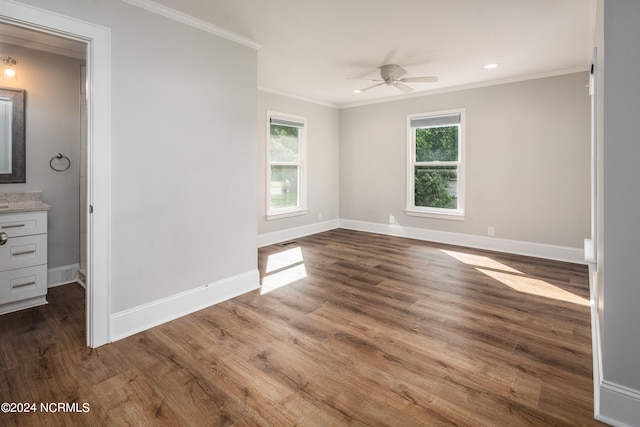 spare room featuring ceiling fan, hardwood / wood-style flooring, and crown molding