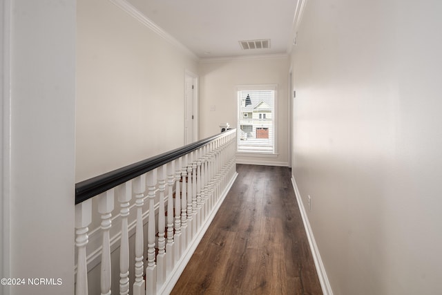 corridor featuring dark wood-type flooring and ornamental molding