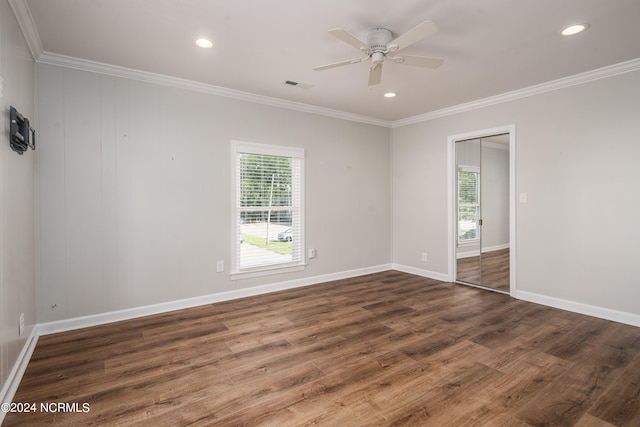 empty room featuring ornamental molding, dark hardwood / wood-style floors, and ceiling fan