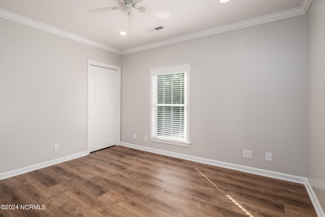 unfurnished room with ceiling fan, crown molding, and dark hardwood / wood-style flooring