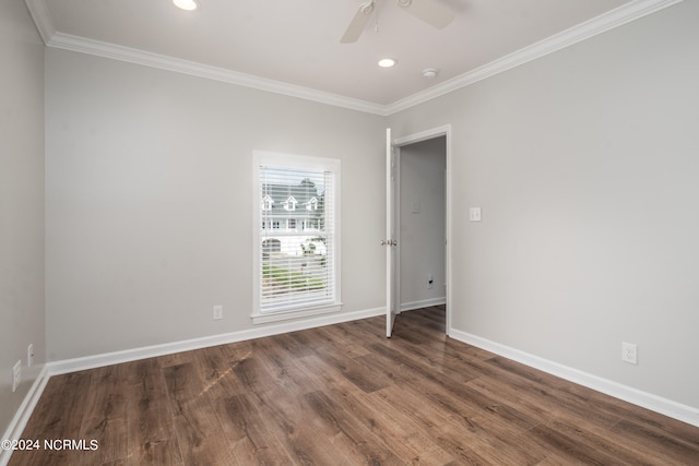 empty room featuring crown molding, dark hardwood / wood-style flooring, and ceiling fan