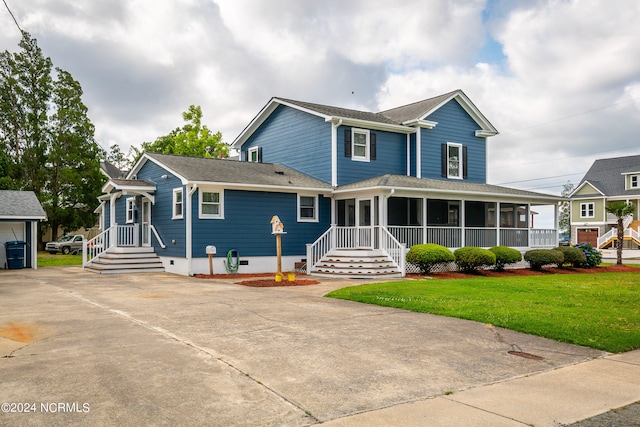 view of front of property with a front lawn and a sunroom