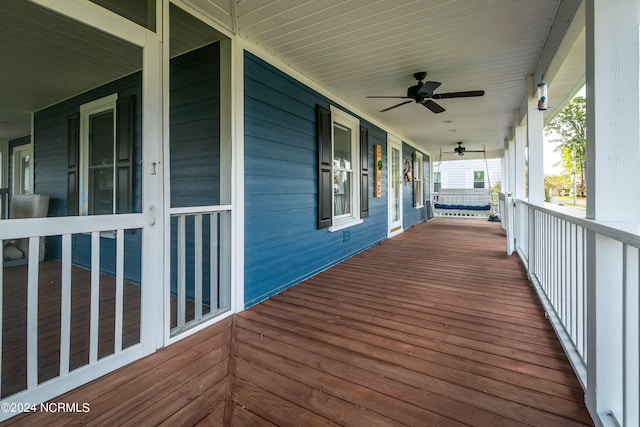 wooden terrace featuring ceiling fan and a porch