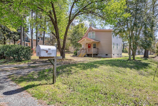 view of front of house featuring driveway, crawl space, and a front yard