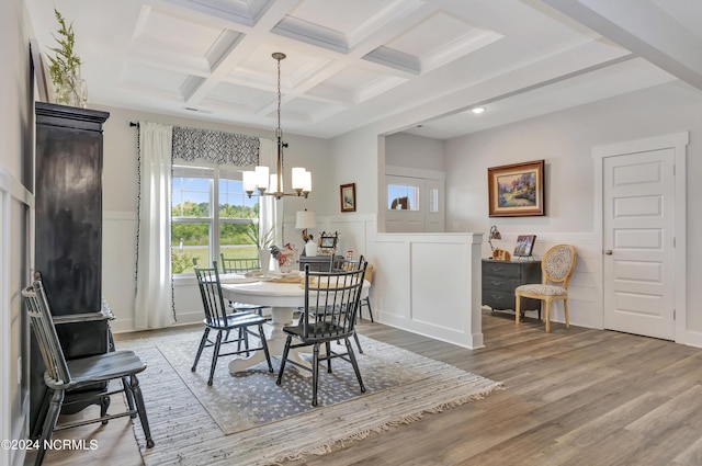 dining room with coffered ceiling, hardwood / wood-style floors, a notable chandelier, and beamed ceiling