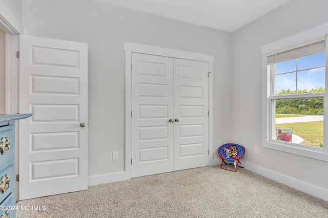 unfurnished bedroom featuring carpet floors and a closet