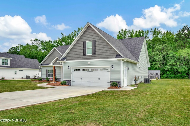 craftsman house featuring a garage, central AC unit, and a front lawn