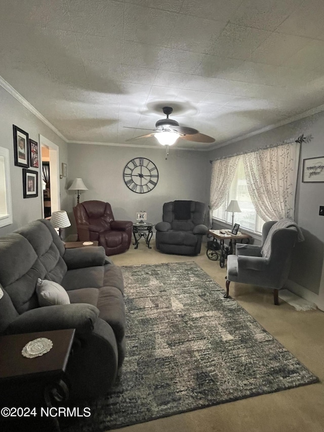 living room featuring ceiling fan, ornamental molding, and carpet flooring