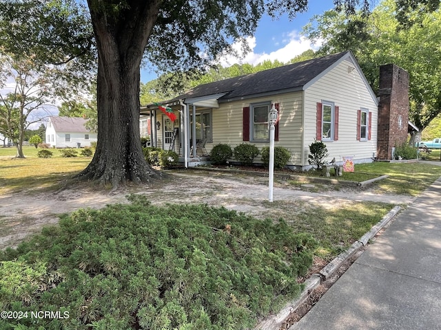 view of front of house with a front yard and a chimney