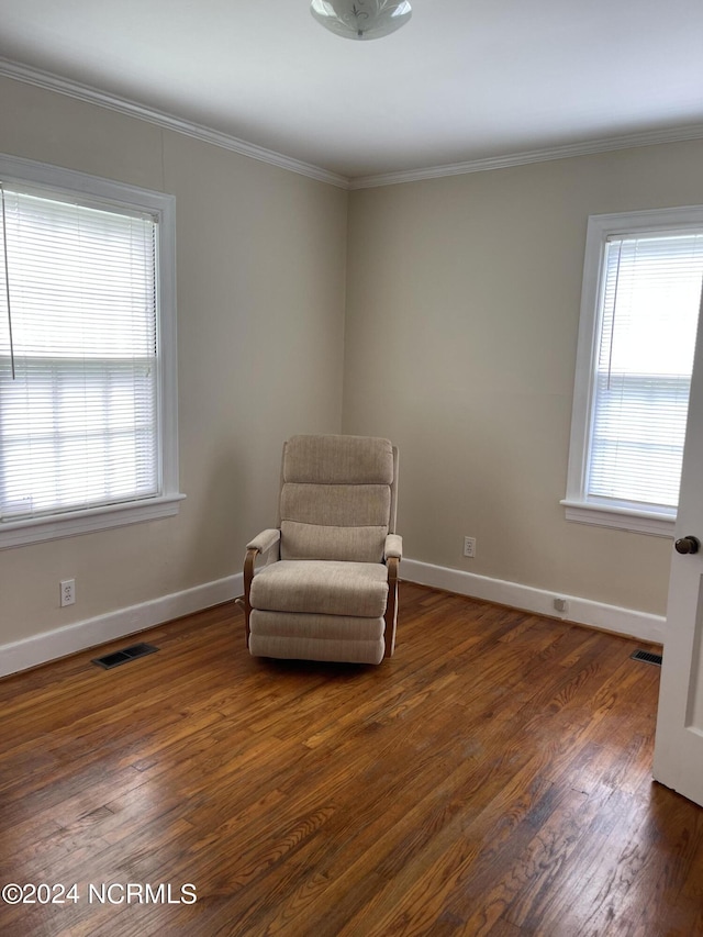 sitting room with baseboards, dark wood finished floors, visible vents, and a healthy amount of sunlight