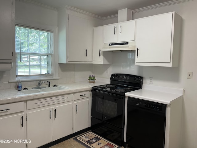 kitchen featuring white cabinets, a sink, under cabinet range hood, and black appliances