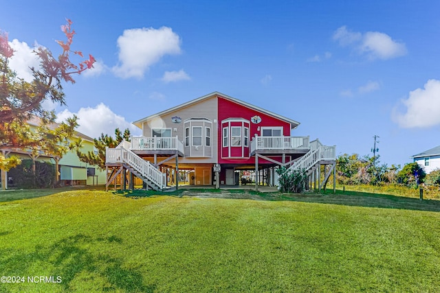 rear view of property with a yard and a deck