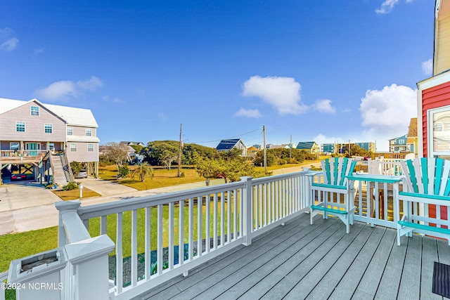 wooden deck featuring a yard