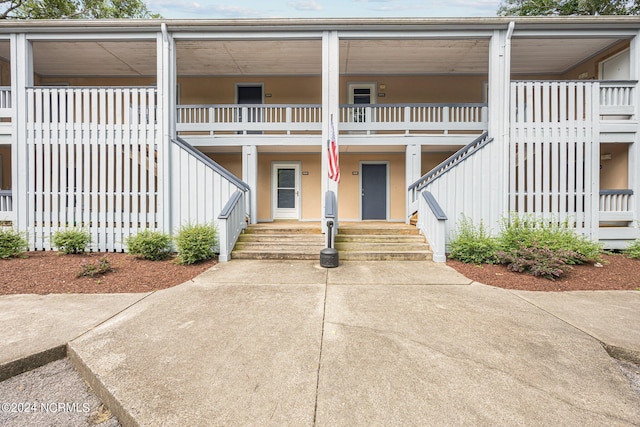 view of front of house with stairs and a porch