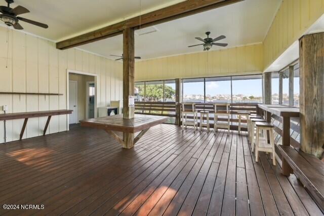 sunroom / solarium with ceiling fan and beamed ceiling