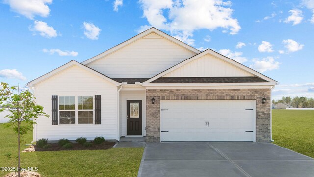 view of front of home with a front yard and a garage