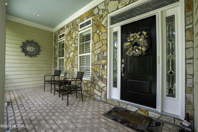 view of exterior entry with a porch