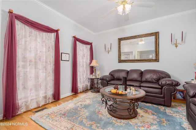 living room with ceiling fan, crown molding, and wood-type flooring