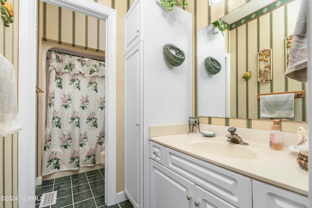 bathroom featuring toilet, vanity, a shower with curtain, and tile patterned flooring