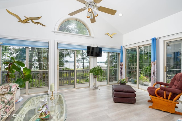 sunroom with ceiling fan and vaulted ceiling