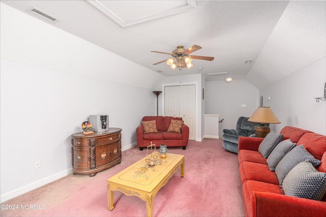 carpeted living room with ceiling fan, vaulted ceiling, and a textured ceiling