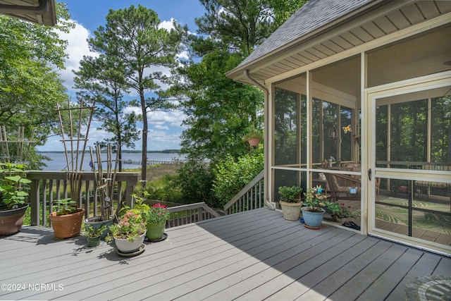 wooden terrace with a sunroom and a water view