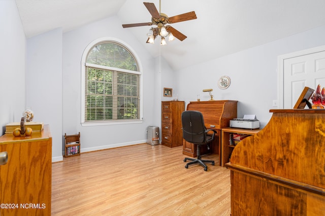 home office with light wood-type flooring, ceiling fan, a wealth of natural light, and vaulted ceiling