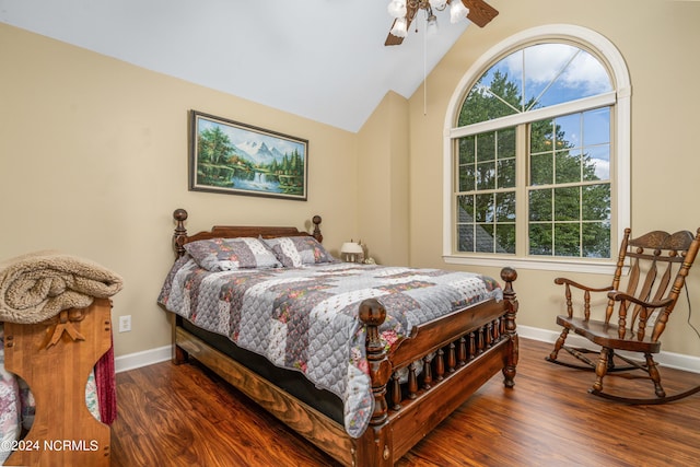 bedroom with ceiling fan, vaulted ceiling, and dark hardwood / wood-style flooring