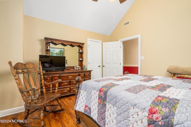 bedroom with ceiling fan, hardwood / wood-style floors, and high vaulted ceiling