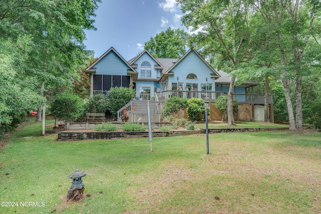 view of front facade with a deck, a sunroom, and a front lawn