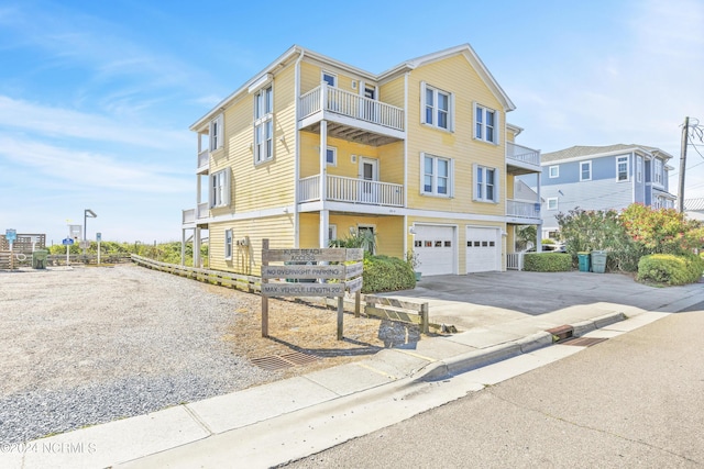 view of property featuring a balcony and a garage