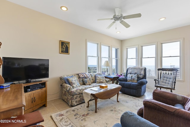 living room featuring light tile patterned floors and ceiling fan