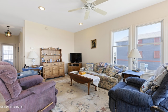 living room with a wealth of natural light and ceiling fan