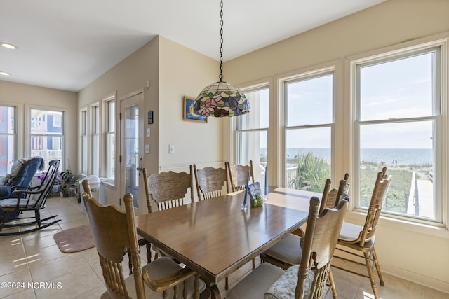 tiled dining space with a water view