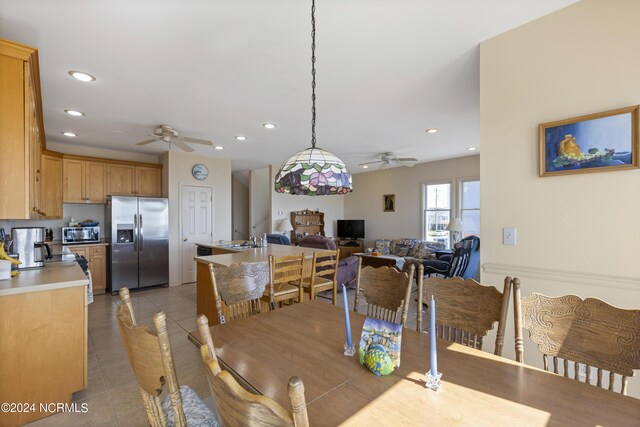 dining space with ceiling fan, sink, and light tile patterned floors