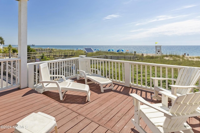 wooden terrace featuring a water view