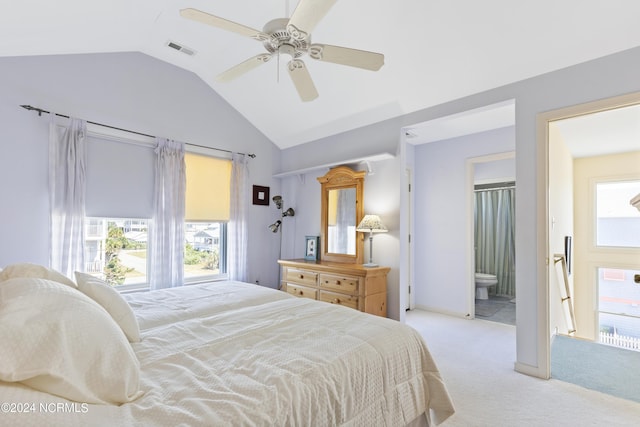 carpeted bedroom with ensuite bath, vaulted ceiling, and ceiling fan