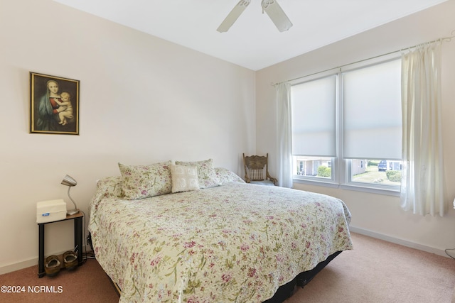 bedroom with ceiling fan and light colored carpet