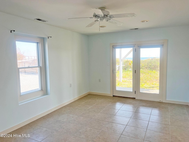 tiled empty room with ceiling fan