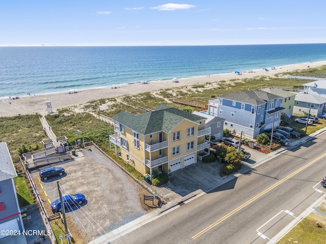 birds eye view of property with a water view and a beach view