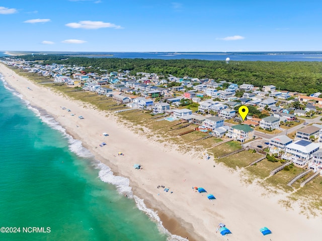 birds eye view of property with a water view and a view of the beach