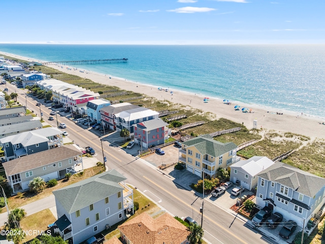 birds eye view of property featuring a water view and a beach view