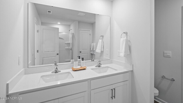 bathroom with vanity, toilet, and an enclosed shower