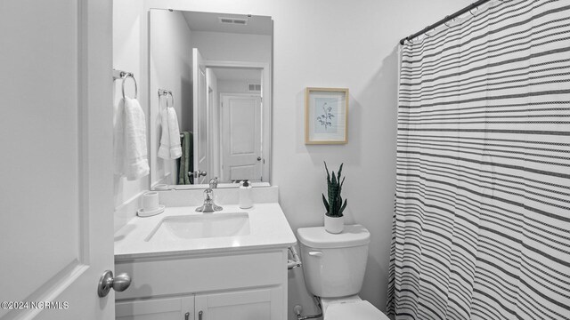 bathroom with vanity, toilet, and a shower with curtain