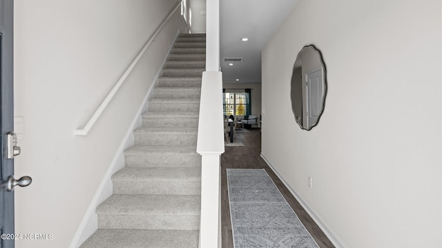 staircase with wood-type flooring