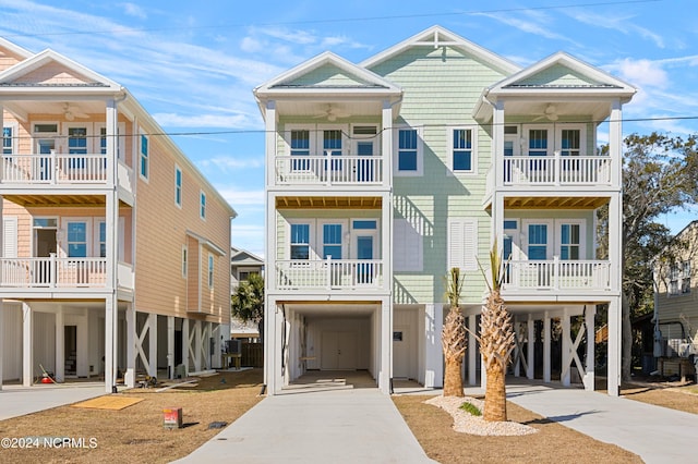 raised beach house featuring central AC unit and a carport