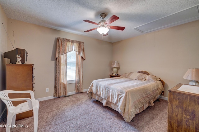 carpeted bedroom featuring a textured ceiling and ceiling fan